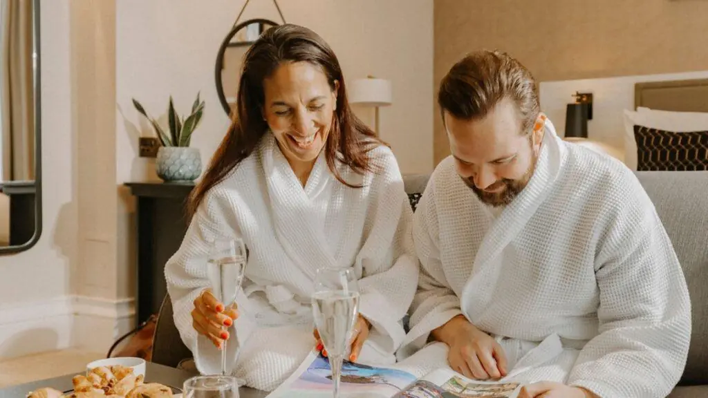 Couple in dressing gowns enjoying wine