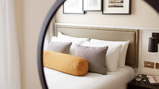Clermont room bed seen through a mirror