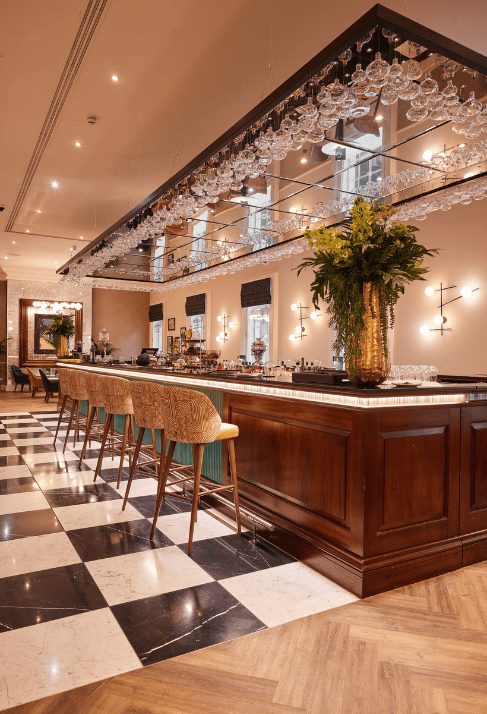 reunion bar with high chairs, hanging glasses, and elegant decor