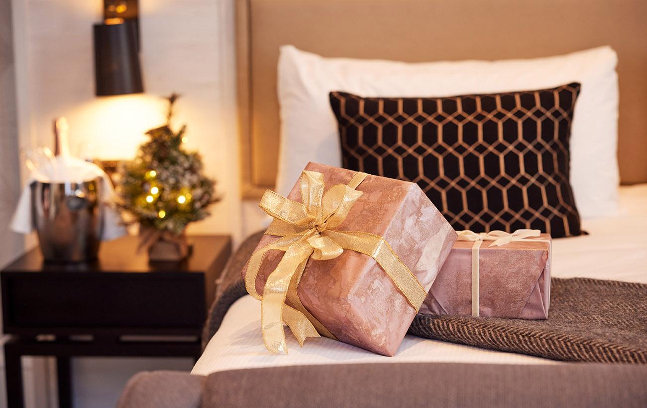 The Clermont Christmas Suite with a gift on the bed