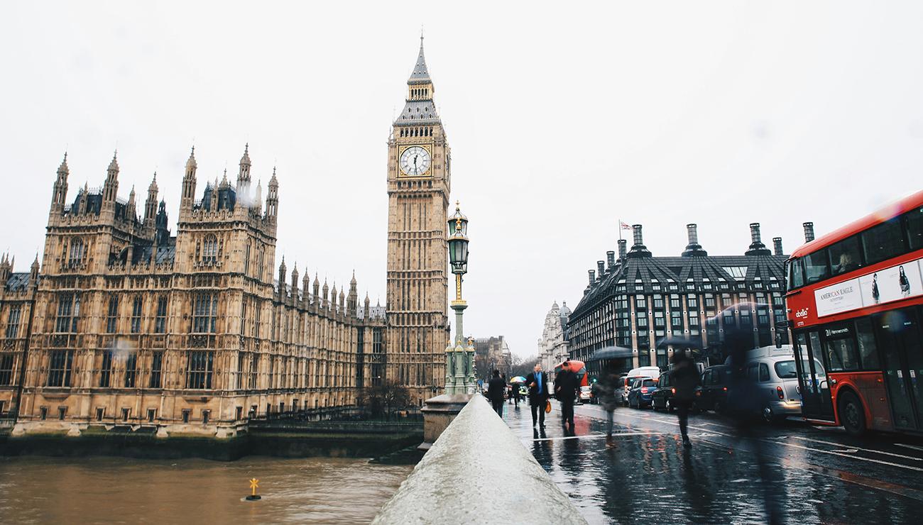 The houses of parliament and Big Ben with an iconic London Bus