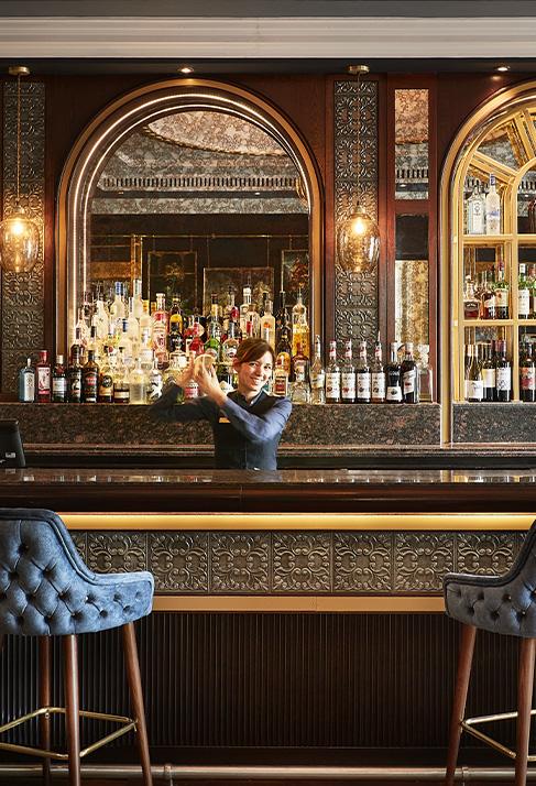 Clermont Charing Cross - Bar Seating area with barman making cocktails