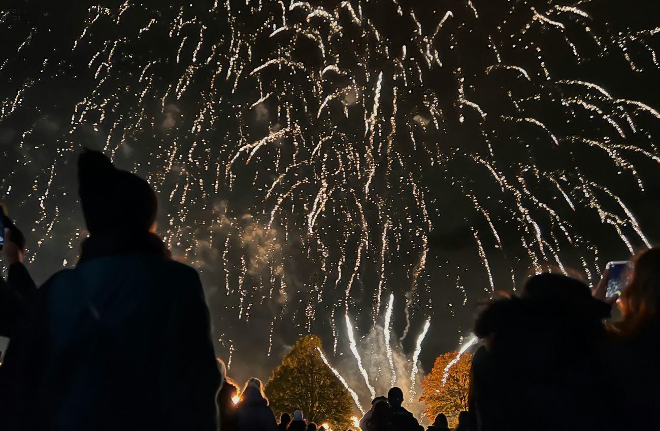 Silhouettes of people watching a Fireworks display
